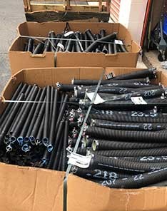 Large boxes filled with black replacement garage door springs in Beacon Hill