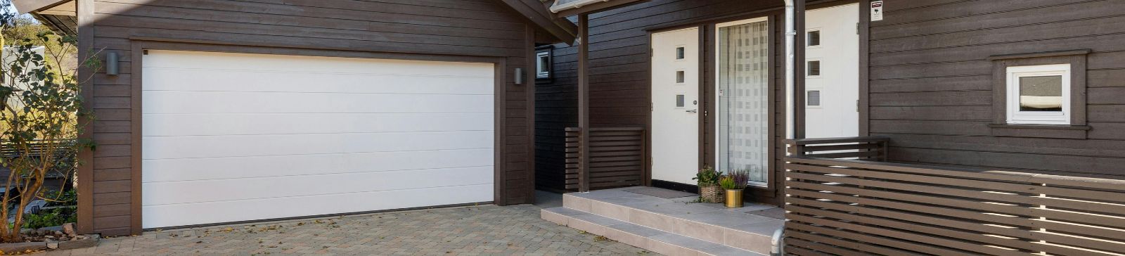 Front view of a Darrington house featuring a contemporary white garage door
