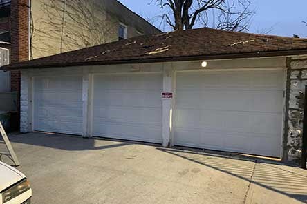 Exterior of triple garage with custom doors and smart opener installed