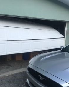 Garage door off track in Steilacoom WA before repairs