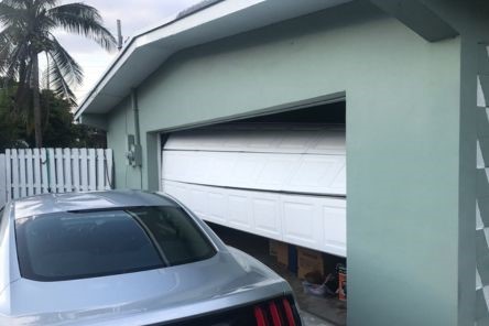 Partially open garage door stuck off track in Steilacoom