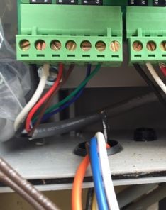 Close-up of garage door opener wiring and terminal connections during Bellevue repair project