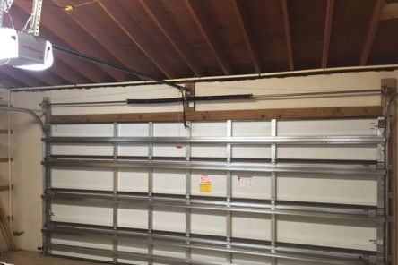 Wide view of residential garage in Bellevue, showing interior of a door with a LiftMaster opener installed