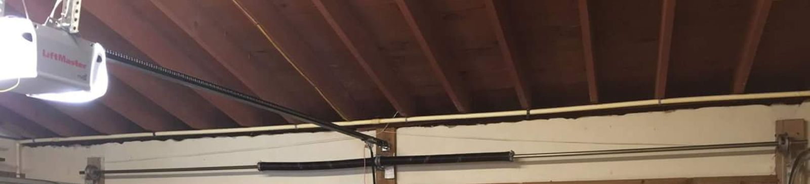 Garage Door Interior with Chain Drive Opener – Bellevue Wide view of residential garage in Bellevue, showing interior of a door with a LiftMaster opener installed