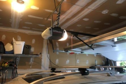 Examining an overhead opener mechanism in a residential Puyallup WA garage.