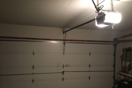 Wide angle of Bellevue garage with closed automatic door and LiftMaster opener on ceiling