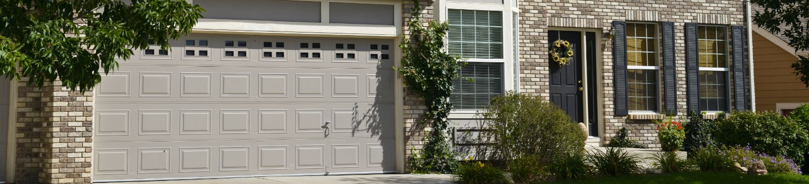 Residential garage door in front of a Bonney Lake home with brick and siding exterior