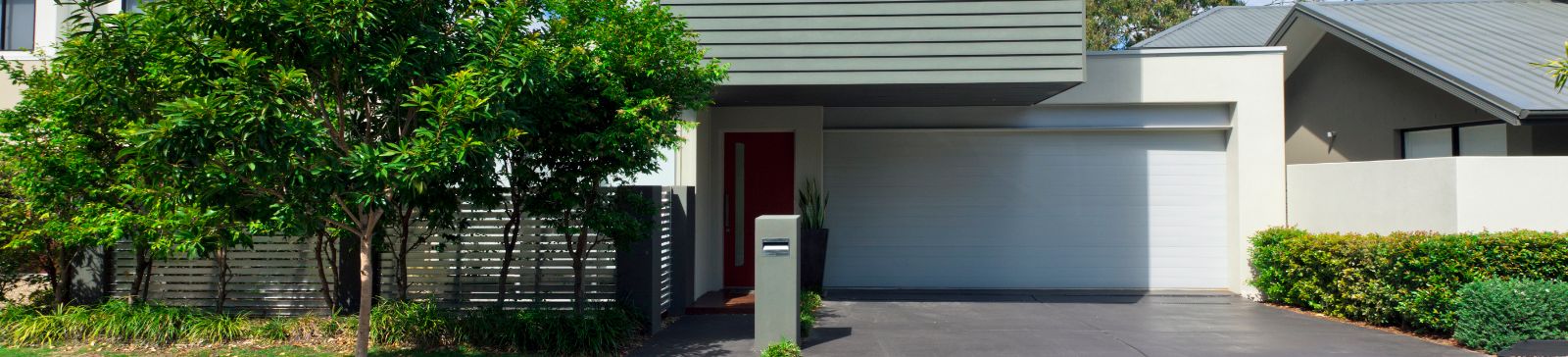 Contemporary home in Buckley, WA with a new white garage door and lush front yard