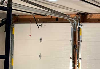 Modern garage interior with dual sectional doors and opener installed in Mercer Island