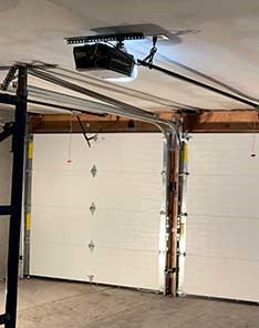 Modern garage interior with dual sectional doors and opener installed in Mercer Island