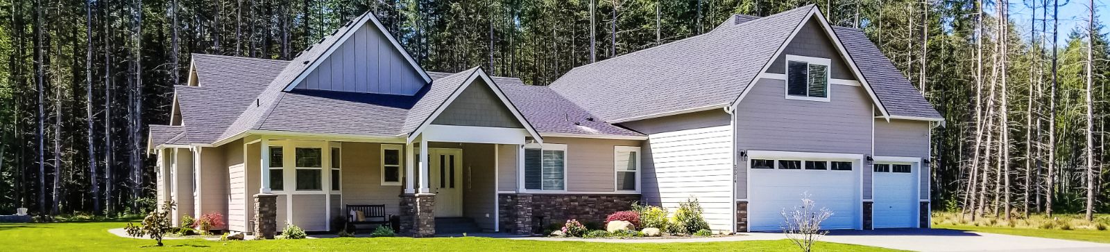 Front view of a modern home with a newly installed garage door, representing professional garage door repair and installation services in Everett, WA.