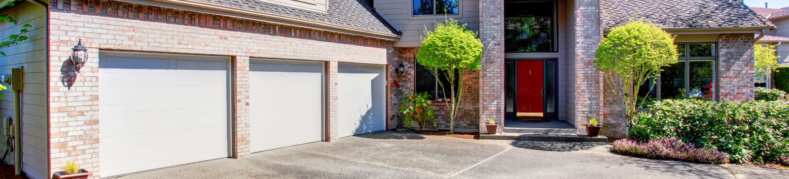 Front view of a modern home with a newly installed garage door, representing professional garage door repair and installation services in Lynnwood, WA.