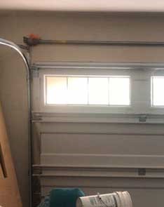 Interior view showing newly installed garage door tracks and top windows in Seattle