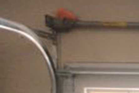 Focus on a garage door torsion spring and end bracket installation in Seattle