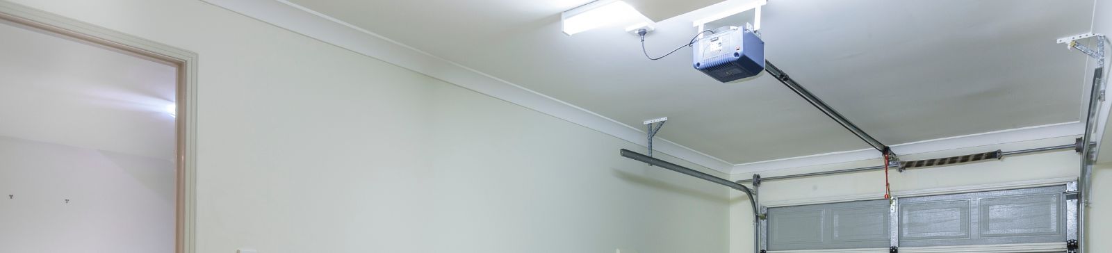 Interior shot showing a Granite Falls garage with an automatic opener and overhead door