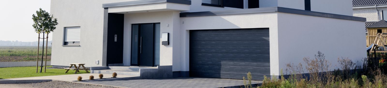 Modern home exterior with a new garage door, representing professional garage door repair and installation services in King County.  Related Reliable garage door repair services in King County