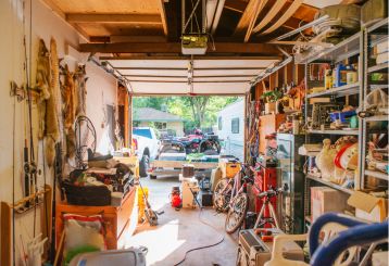 Interior view of a well-organized, clutter-free garage with neatly stored tools, bikes, and equipment, illustrating the importance of garage cleaning and organization.