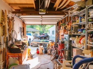 Main Reasons to Keep Your Garage Clean and Clutter Free – Organized Garage Example Interior view of a well-organized, clutter-free garage with neatly stored tools, bikes, and equipment, illustrating the importance of garage cleaning and organization.