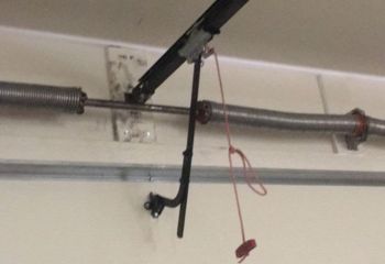 Torsion spring securely mounted above a sectional garage door in Tacoma, WA after professional replacement