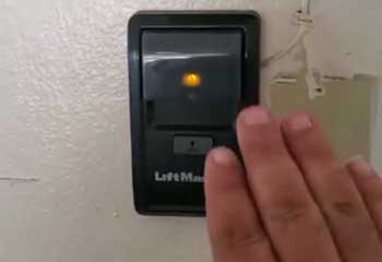 Interior wall-mounted LiftMaster garage door control with light switch in Seattle