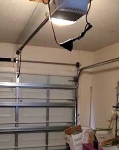 Overhead view of an installed automatic garage door opener inside a Seattle garage