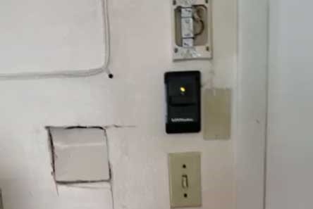 Interior wall-mounted LiftMaster garage door control with light switch in Seattle