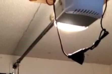 Overhead view of an installed automatic garage door opener inside a Seattle garage
