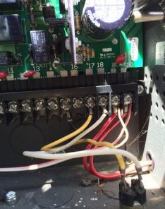 Detailed image of a garage door opener circuit board and wiring, serviced for motor gear replacement in Renton