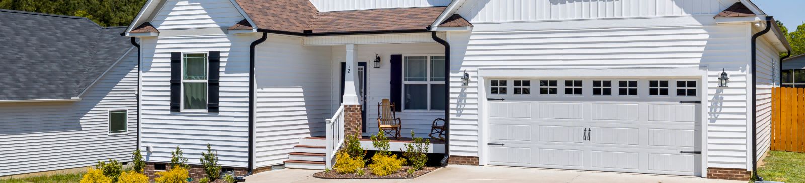 Modern residential home exterior with a new garage door, representing professional garage door repair and installation services in Pierce County.